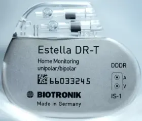 Photo of a medical device: "Estella DR-T Home Monitoring unipolar/bipolar" 2D barcode "66033245." Biotronik logo "Made in Germany"