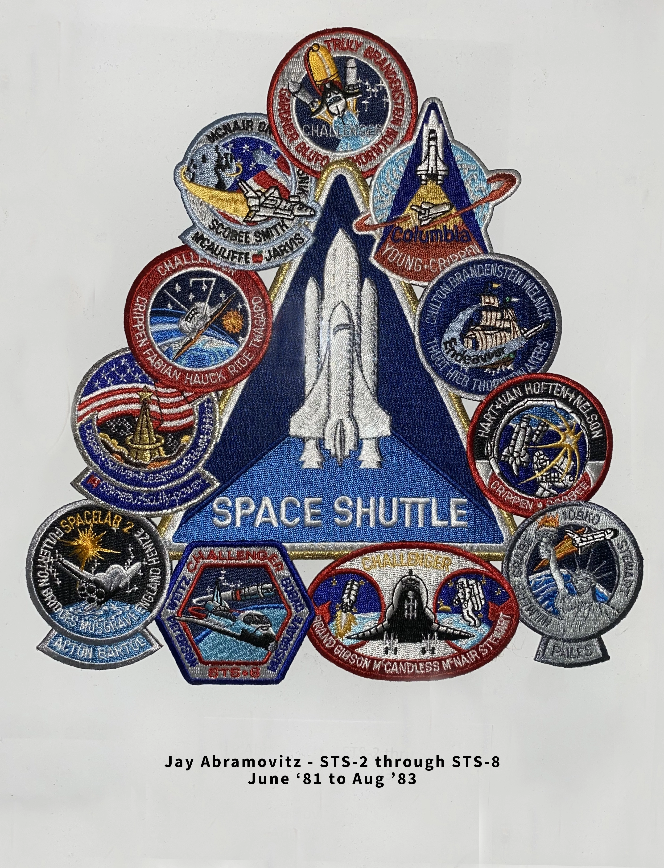 Photo of twelve space shuttle patches for various missions.  Caption: Jay Abramovitz - STS-2 through STS-8 Jun '81 to Aug '83